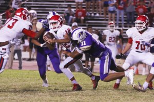 The Tigers Joseph Oldham-Rodriguez tackles Sanger quarterback Blake Wolf in Friday night action in Tiger Stadium.